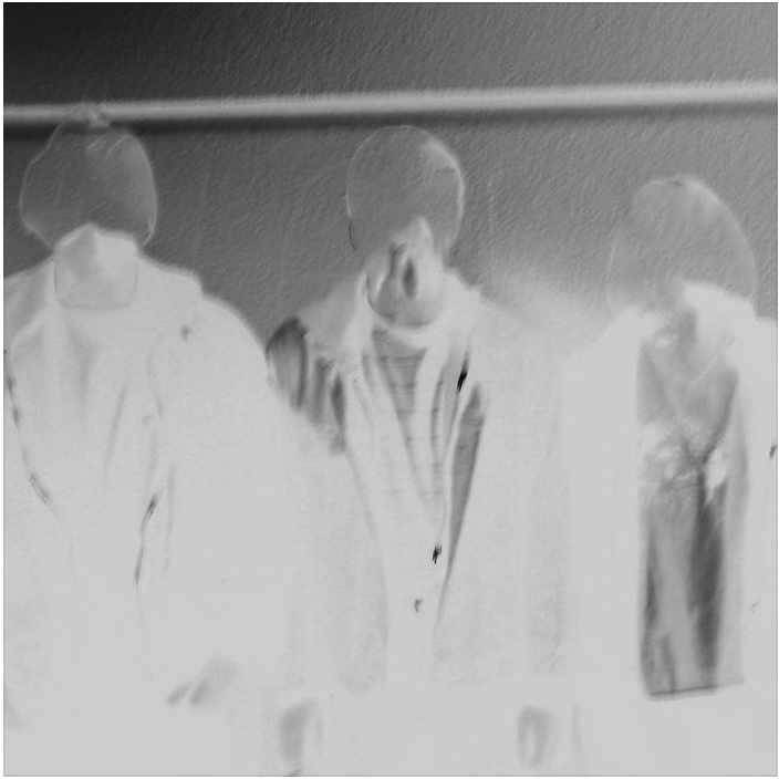 artwork for cellmate: a photo negative image of three people standing in front of a wall at night; they are wearing jackets and t-shirts; the outlines of their heads  are visible but their faces have been blended in the background