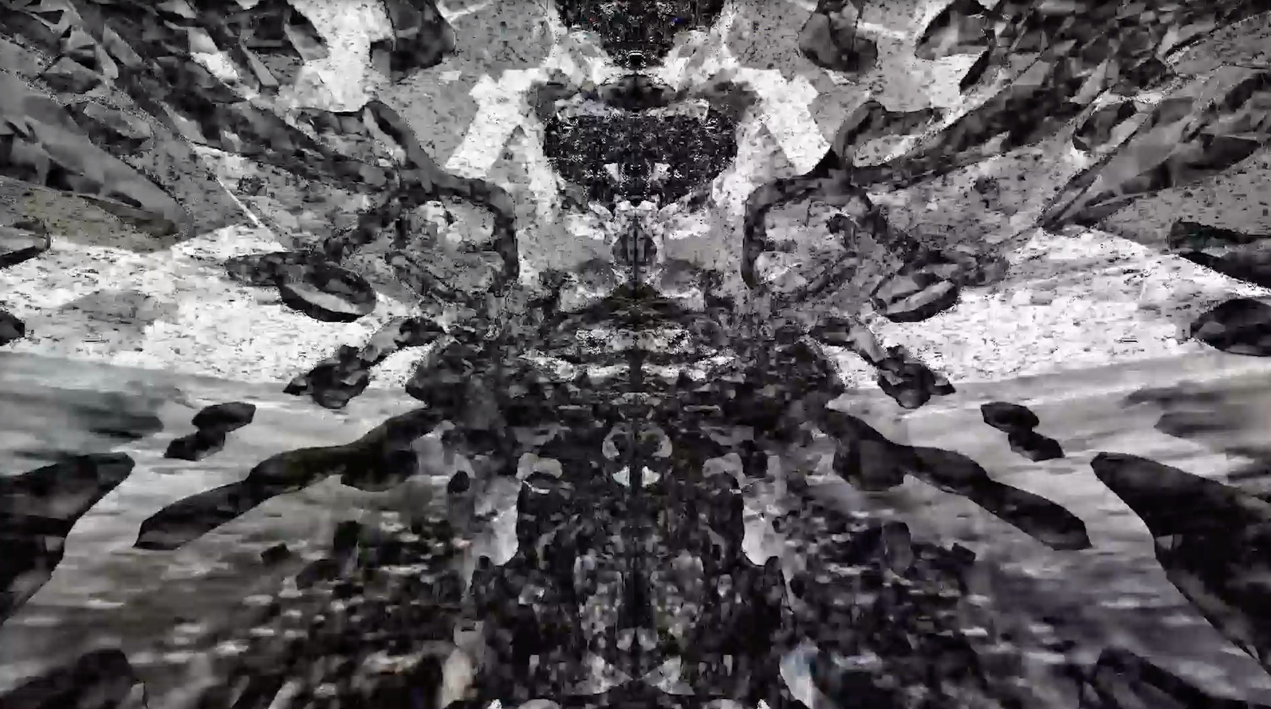 a black and white image of glitchy, 3D rendered water, reflected across the vertical axis; the water droplets are splashing outward to the edge of the image from the center and are grey and black on a white and grey background